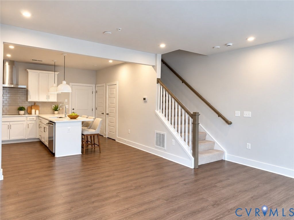 4113 Greybull Drive, #A, Gateway Square, Henrico, VA 23233 Virtually staged. Open-concept living area with wood-finish flooring, recessed lighting, and a modern kitchen