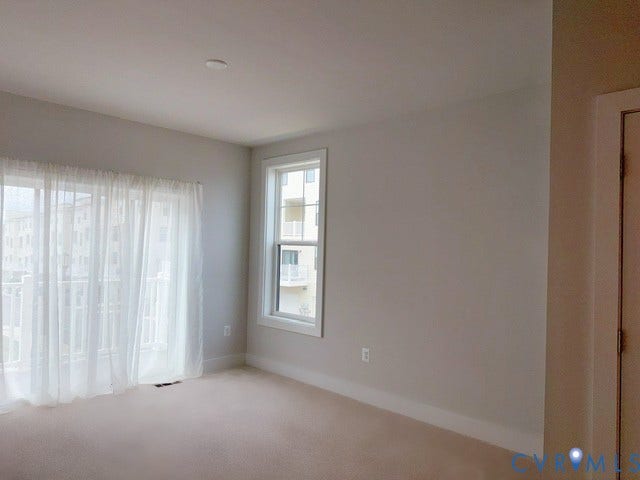 4113 Greybull Drive, #A, Gateway Square, Henrico, VA 23233 Bright corner room with expansive windows featuring sheer drapery, neutral carpeting, and fresh white walls
