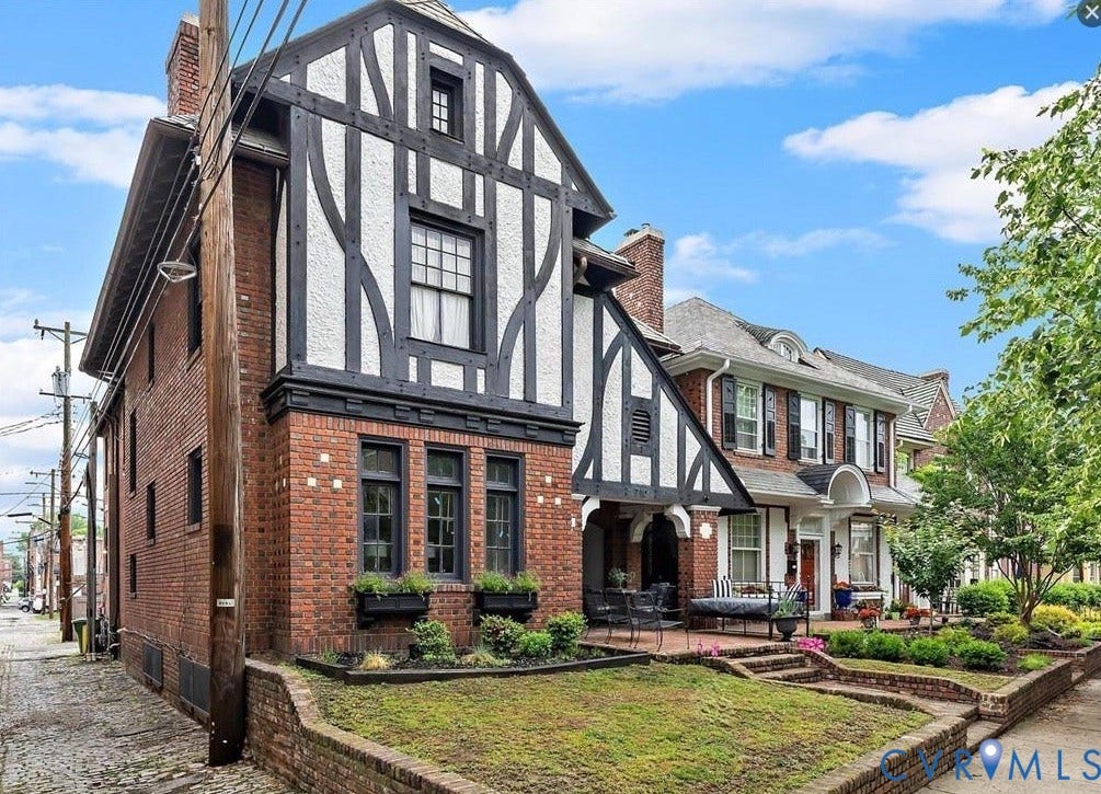 710 N Arthur Ashe Boulevard, Historic Fan District, Richmond, VA 23220 Brick exterior with half-timber detailing, multiple chimneys, a covered porch, and a terraced front yard