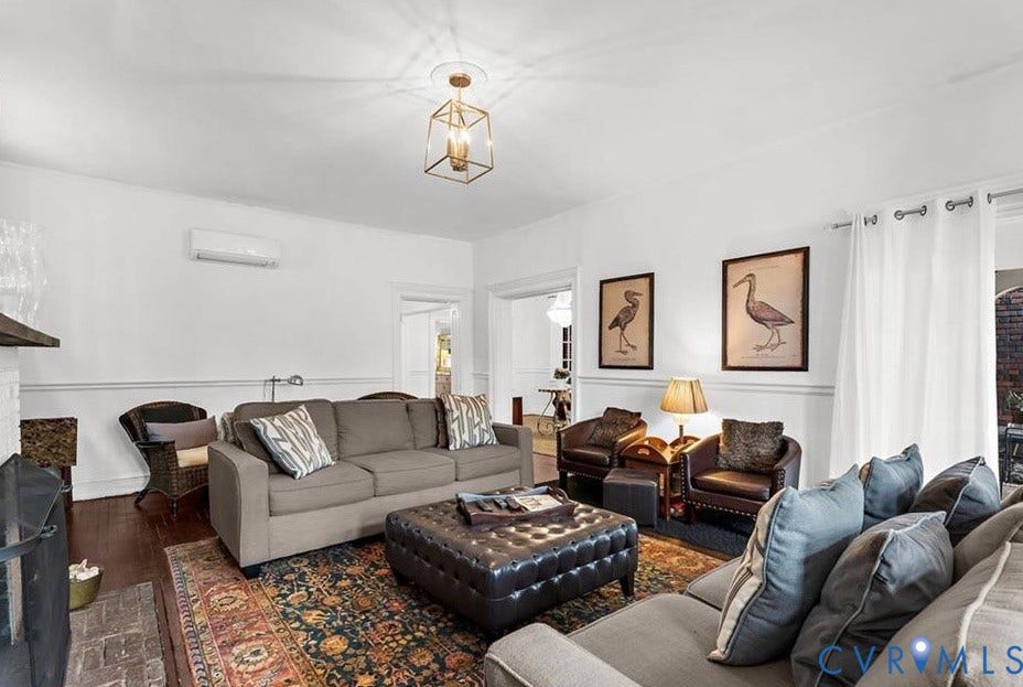 710 N Arthur Ashe Boulevard, Historic Fan District, Richmond, VA 23220 Hardwood flooring, crown molding, a decorative fireplace with a brick hearth, and a brass-tone geometric ceiling fixture