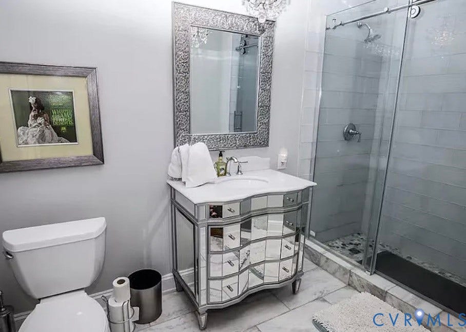 710 N Arthur Ashe Boulevard, Historic Fan District, Richmond, VA 23220 Mirrored vanity with a white countertop and undermount sink
