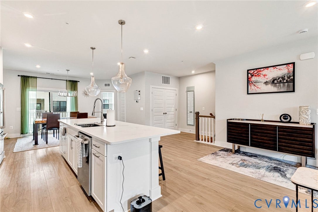 528 Greybull Walk, #B, Glen Allen, VA 23233 Open concept living space featuring wood-finish flooring, recessed lighting, and a kitchen island with a built-in sink and pendant lighting