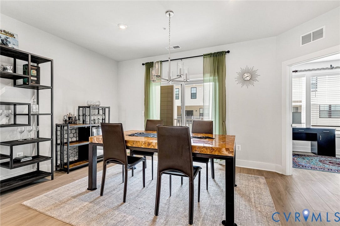 528 Greybull Walk, #B, Glen Allen, VA 23233 Recessed lighting, wood-finish flooring, and a contemporary chandelier illuminate this space