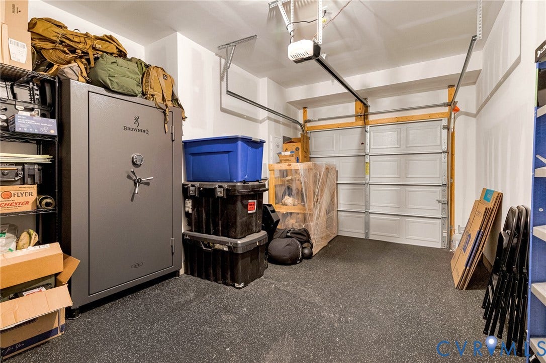 528 Greybull Walk, #B, Glen Allen, VA 23233 Garage space featuring a paneled overhead door, rubberized flooring, and an automatic door opener
