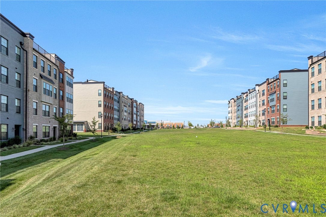 528 Greybull Walk, #B, Glen Allen, VA 23233 Expansive green space flanked by multi-story residential buildings featuring brick, siding, and balconies