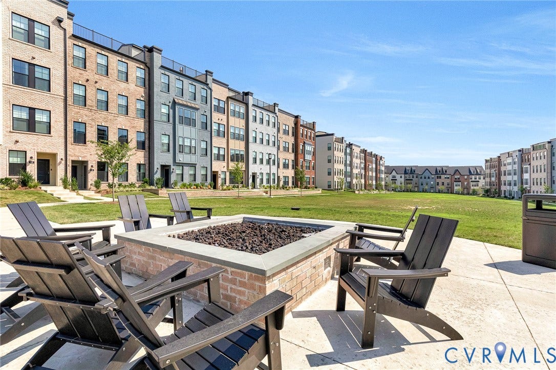 528 Greybull Walk, #B, Glen Allen, VA 23233 Paved outdoor fire pit area with brick and stone detailing, surrounded by green space