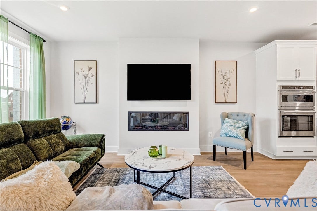 528 Greybull Walk, #B, Glen Allen, VA 23233 Recessed lighting, wood-finish flooring, a built-in linear fireplace, a built-in double oven, and white cabinetry