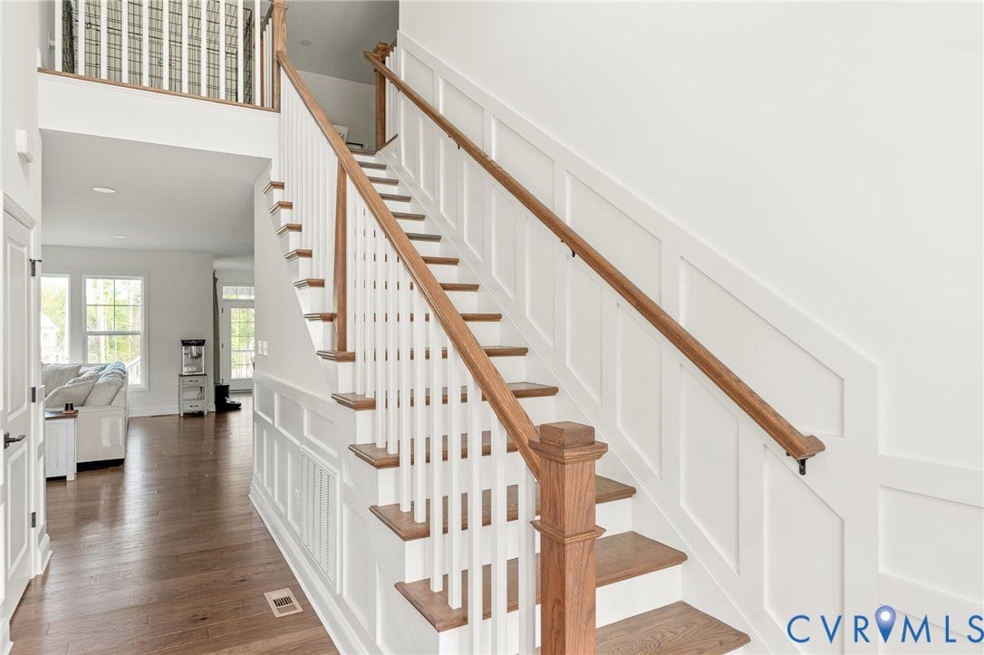 18325 Barrin Court, Barrington, Moseley, VA 23120 Hardwood stair treads and risers, wood-finish flooring, white paneling, white balusters, and a wood-finish handrail