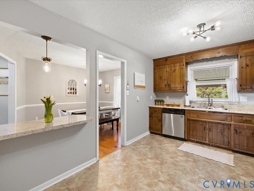 12724 S Chester Road, Chesterfield, VA 23831 Kitchen featuring wood cabinetry, new stainless steel dishwasher, and a modern ceiling light fixture
