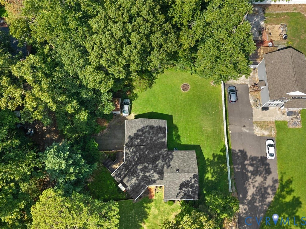 12724 S Chester Road, Chesterfield, VA 23831 Aerial property view featuring a new shingle roof, established trees, a manicured lawn, and paved driveway