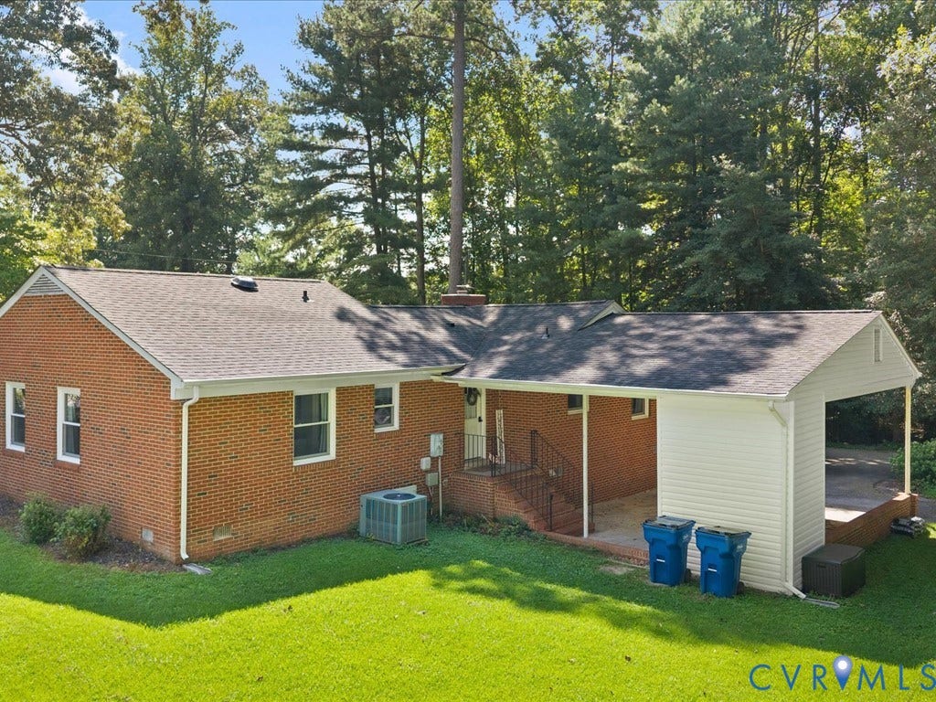 12724 S Chester Road, Chesterfield, VA 23831 Brick exterior with a covered carport, covered patio, and mature trees surrounding the property