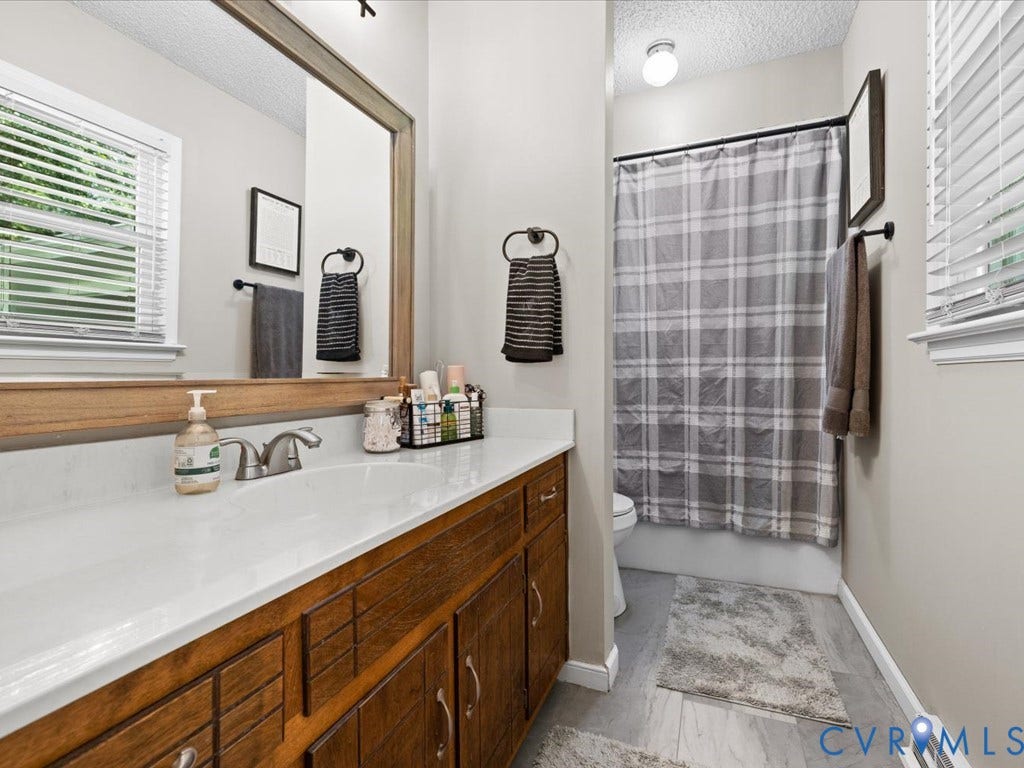 12724 S Chester Road, Chesterfield, VA 23831 Single vanity with wood-finish cabinetry and a white countertop