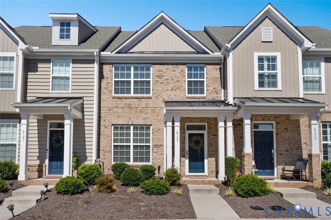 Brick and siding exterior with multiple gables and a dormer