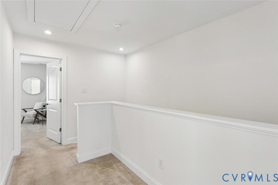 Endless possibilities in this bright hallway alcove! Whether you transform it into a sunlit reading space, a mini library, or a dedicated workspace, this extra square footage is ready for your personal touch.