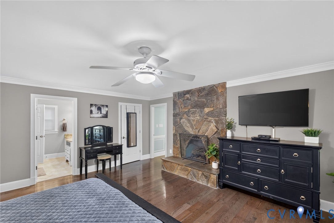 12800 Leffingwell Court, Henrico, VA 23233 Hardwood flooring, stone-clad fireplace with hearth, ceiling fan with light fixture, crown molding, and recessed lighting