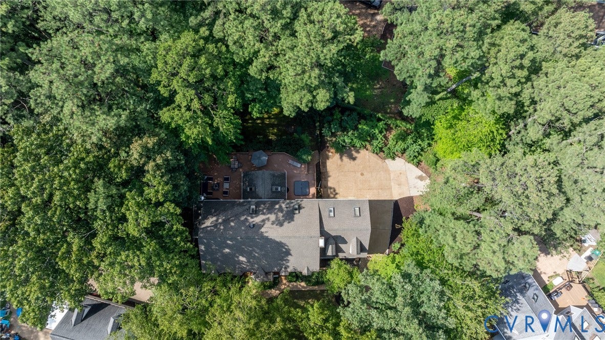 12800 Leffingwell Court, Henrico, VA 23233 Expansive lot with mature trees, a multi-level roofline, and an integrated paved driveway