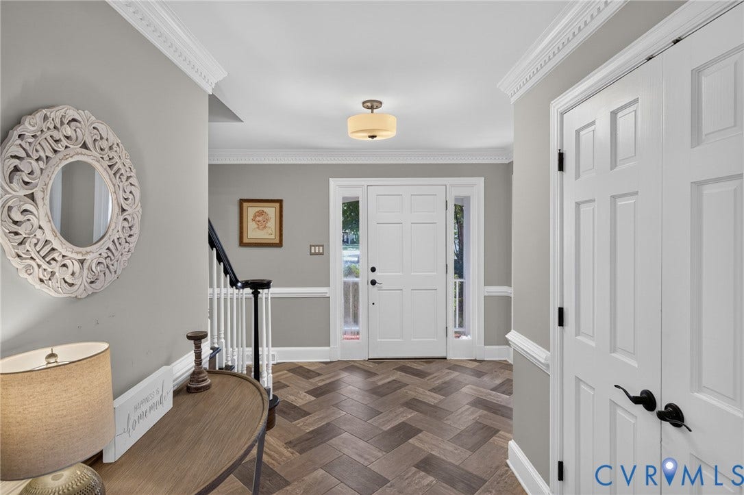 12800 Leffingwell Court, Henrico, VA 23233 Herringbone wood-finish flooring, paneled entry door with sidelights, crown molding, chair rail molding, and staircase with painted balusters