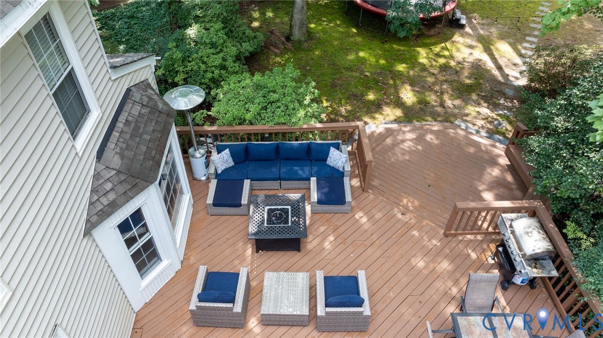 12800 Leffingwell Court, Henrico, VA 23233 Expansive wood-finish deck with integrated railings and a bay window extension