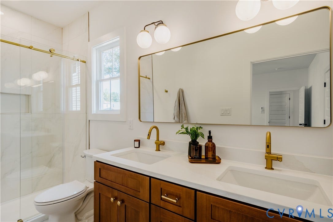3106 Groveland Avenue, Richmond, VA 23222 Dual vanity with wood-finish cabinetry, white countertop, and gold-finish fixtures