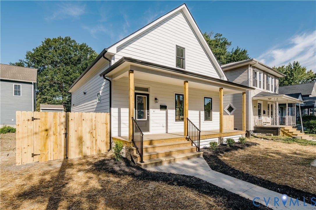 3106 Groveland Avenue, Richmond, VA 23222 White siding exterior with a covered porch, wood posts, black railings, and a concrete walkway