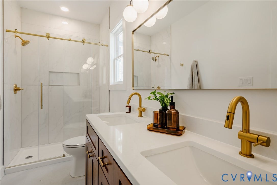 3106 Groveland Avenue, Richmond, VA 23222 Dual vanity with white countertop, rich wood-finish cabinetry, and gold-tone fixtures