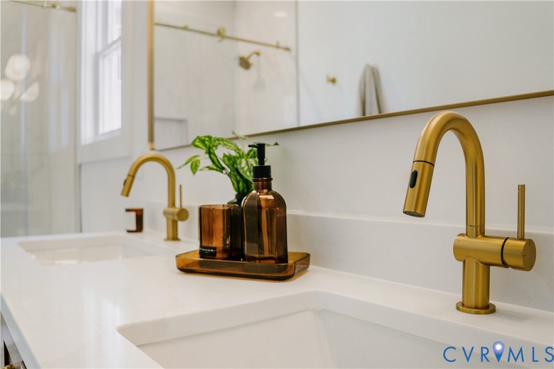 3106 Groveland Avenue, Richmond, VA 23222 Dual integrated sinks with contemporary gold-tone faucets, set in a white solid surface countertop