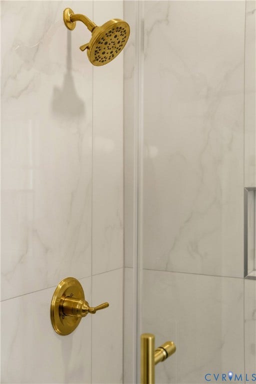 3106 Groveland Avenue, Richmond, VA 23222 Shower with brass fixtures, glass enclosure, and white tile surround