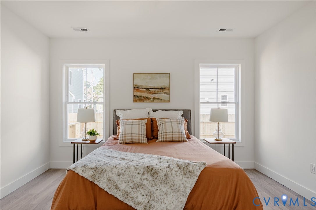 3106 Groveland Avenue, Richmond, VA 23222 Neutral wall colors, wood-finish flooring, two large windows, and a ceiling fan