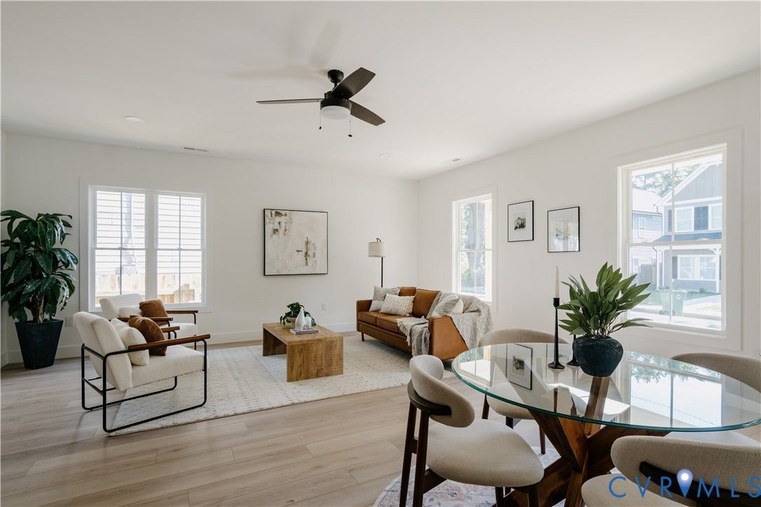 3106 Groveland Avenue, Richmond, VA 23222 Open-concept living space featuring wood-finish flooring, multiple windows with white trim, and a ceiling fan