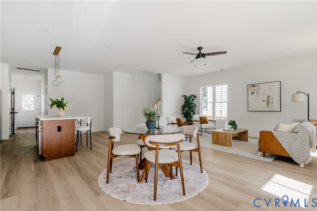 3106 Groveland Avenue, Richmond, VA 23222 Open-concept living area featuring wood-finish flooring, a kitchen island with seating, pendant lighting, and a ceiling fan