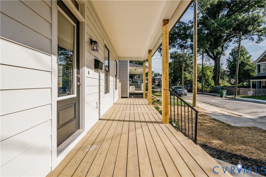 3106 Groveland Avenue, Richmond, VA 23222 Expansive front porch featuring natural wood decking, sturdy wood columns, and a black metal railing