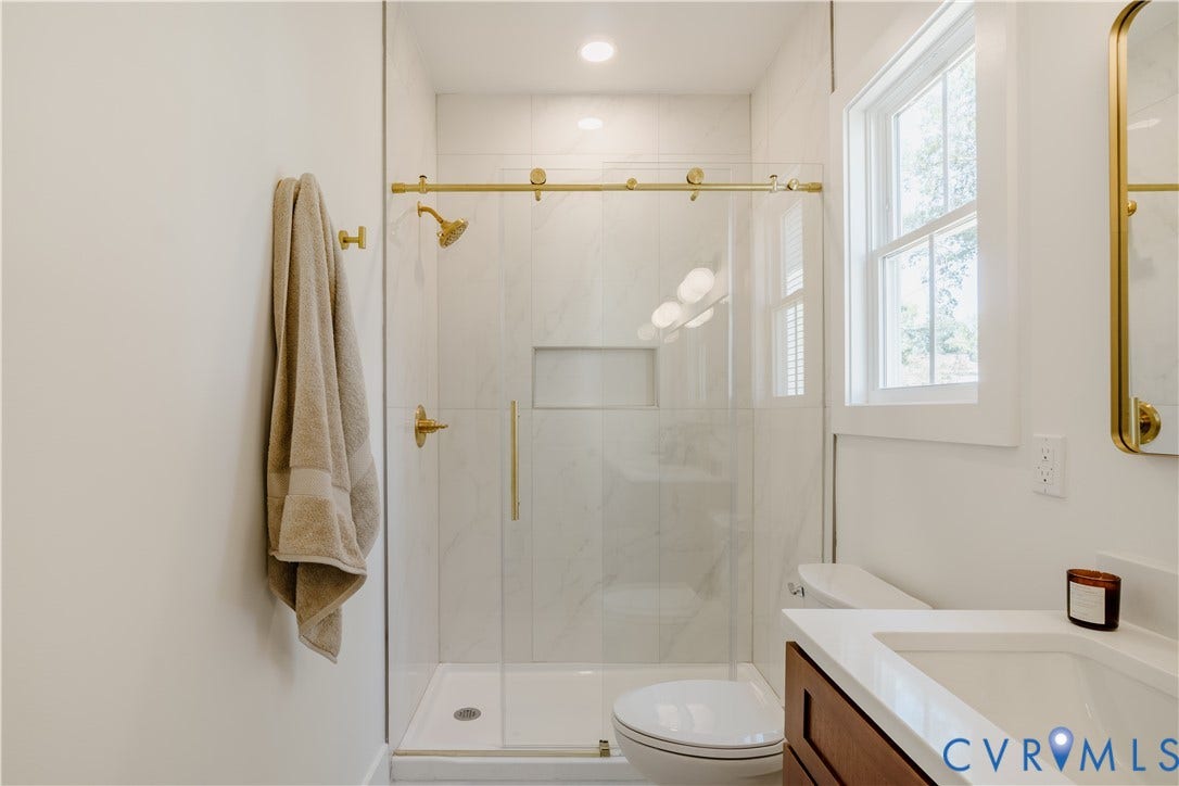 3106 Groveland Avenue, Richmond, VA 23222 Glass-enclosed shower with gold-tone fixtures and recessed niche