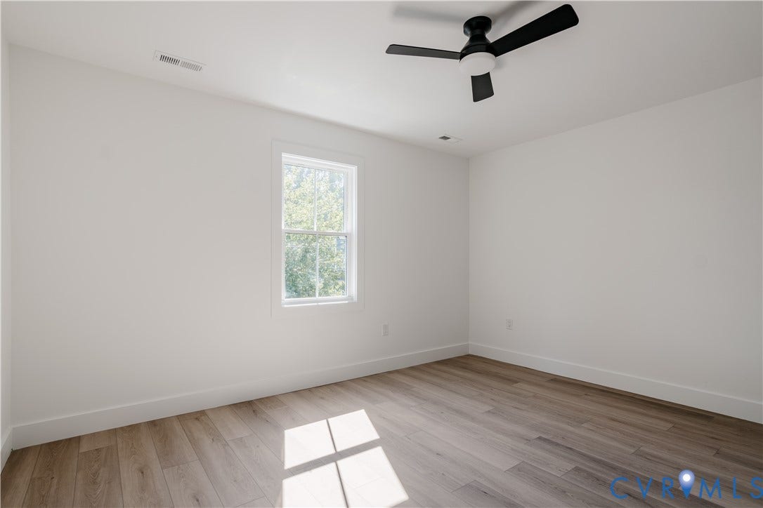 3106 Groveland Avenue, Richmond, VA 23222 Wood-finish flooring, white walls, and a window providing natural illumination
