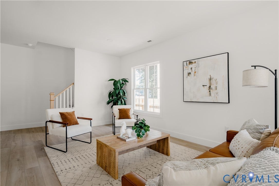 3106 Groveland Avenue, Richmond, VA 23222 Bright living space featuring wood-finish flooring and a staircase with painted risers and wood handrails