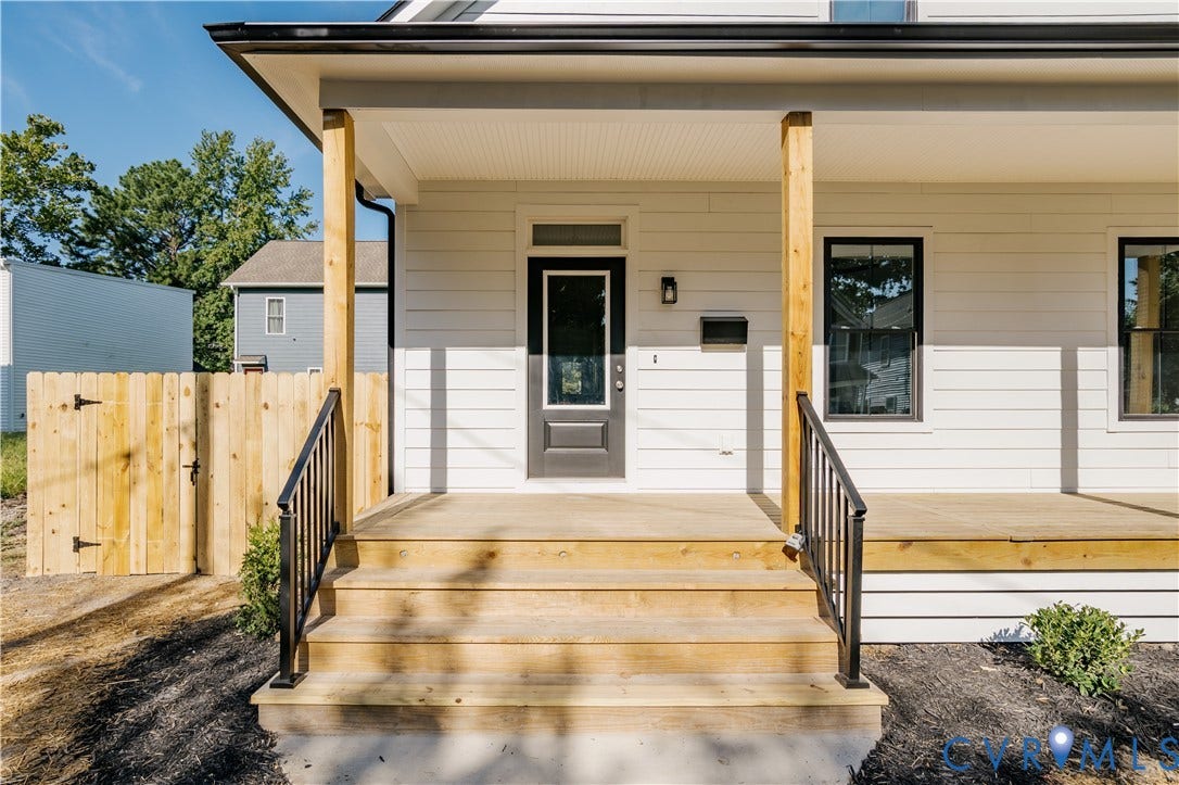 3106 Groveland Avenue, Richmond, VA 23222 Inviting front porch with natural wood steps, black metal railings, and a solid front door