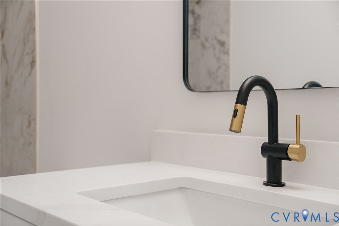 3106 Groveland Avenue, Richmond, VA 23222 Integrated sink with a white countertop and a matte black and gold-tone faucet