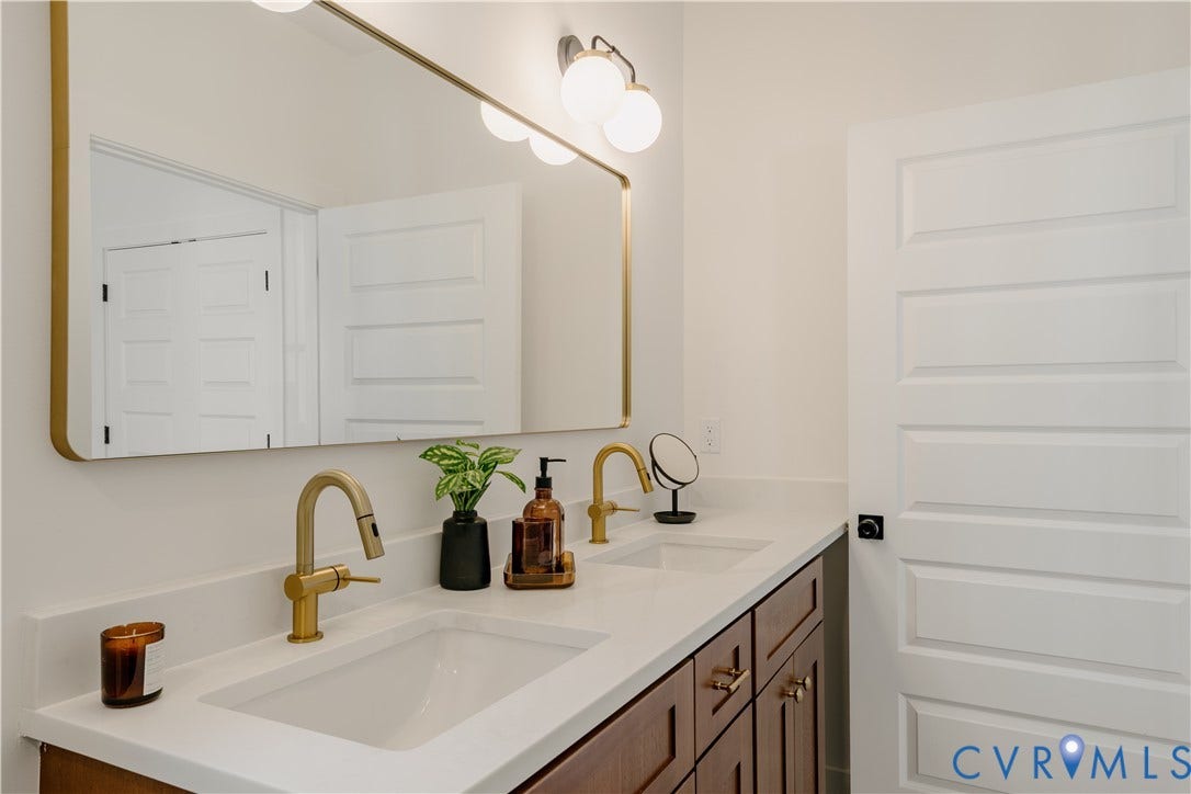 3106 Groveland Avenue, Richmond, VA 23222 Double vanity with integrated sinks, brushed gold faucets, and a white countertop