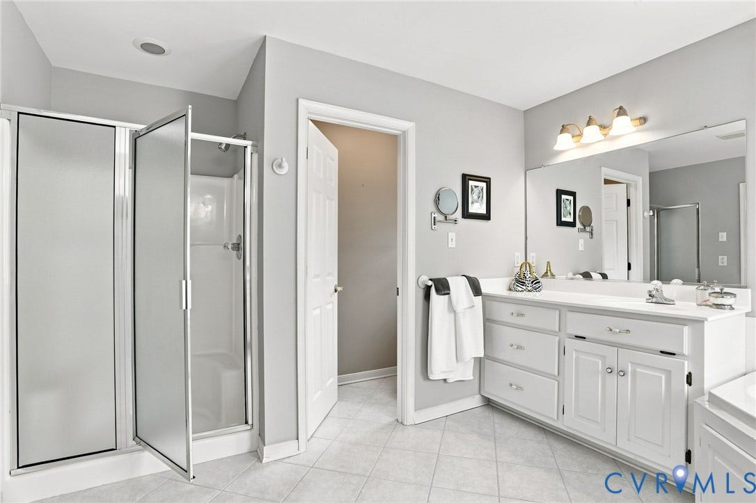 5712 Stephens Point Court, Stephens Point, Chester, VA 23831 Spacious primary bath features a separate shower, dual vanities, and a neutral color palette.