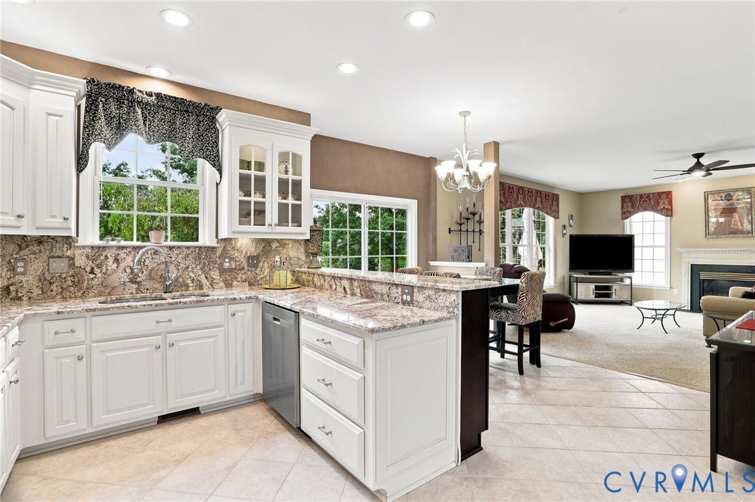 5712 Stephens Point Court, Stephens Point, Chester, VA 23831 Spacious kitchen features white cabinetry, generous counter space, and an open layout connecting to the family room.