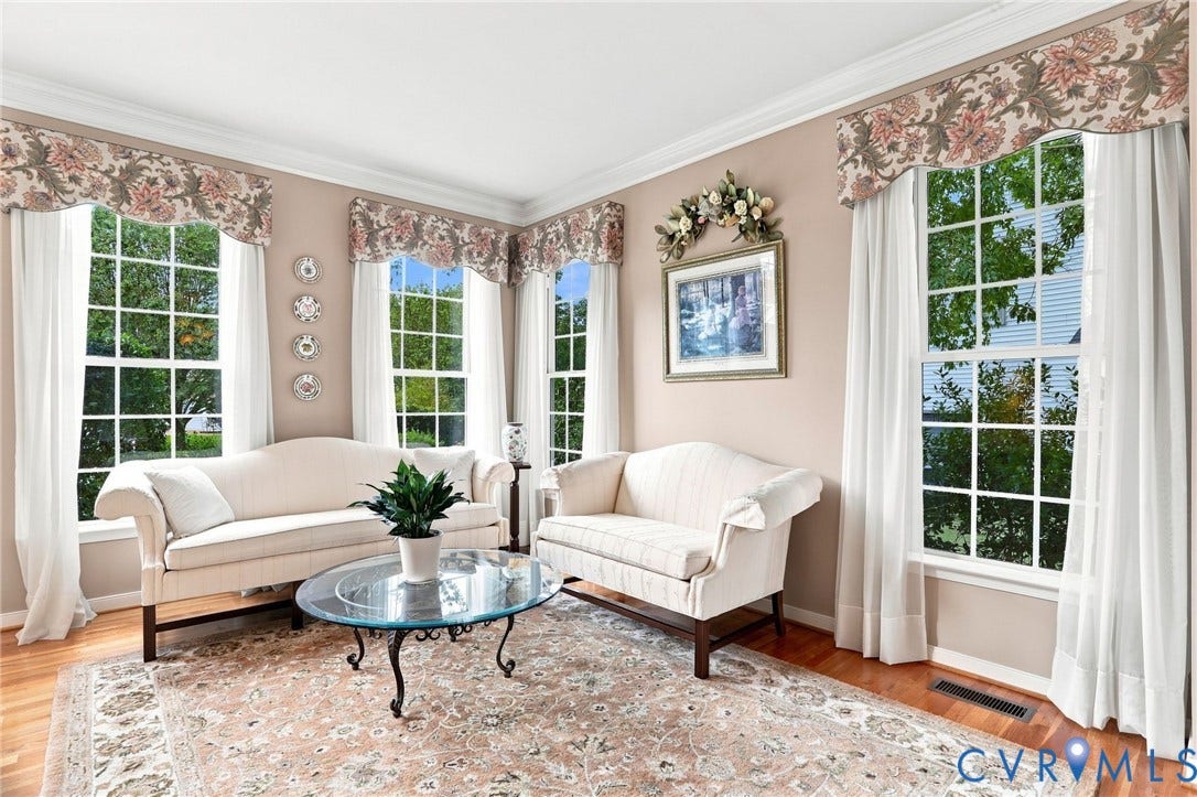 5712 Stephens Point Court, Stephens Point, Chester, VA 23831 Bright formal living room features hardwood floors, crown molding, and an abundance of natural light from multiple windows.