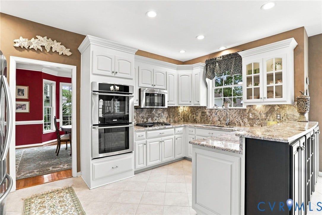 5712 Stephens Point Court, Stephens Point, Chester, VA 23831 Spacious kitchen features white cabinetry, granite countertops, double ovens, stainless steel appliances, and abundant storage and prep space.