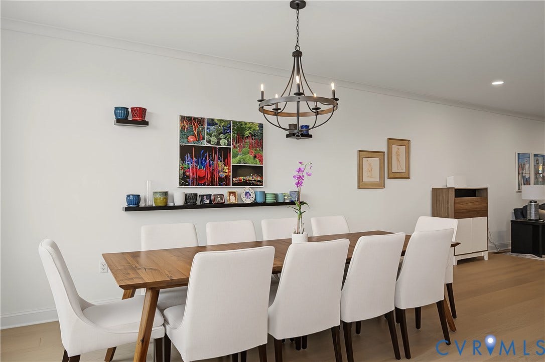 Hardwood flooring, crown molding, recessed lighting, and a chandelier with a dark bronze finish
