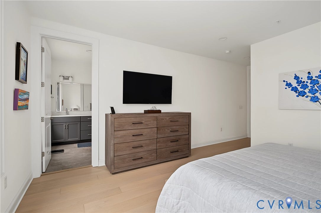 Light wood-finish flooring with white walls