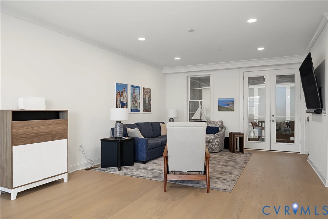 Recessed lighting, wood-finish flooring, and white paneled doors