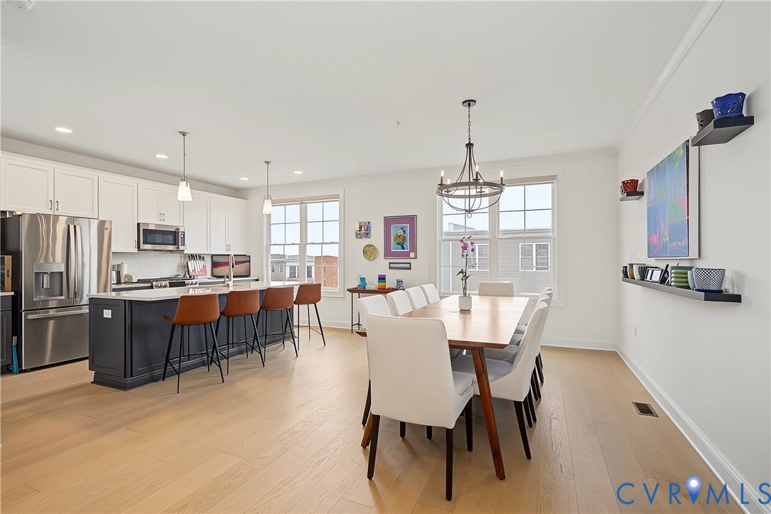 Open-concept kitchen and dining area featuring light wood-finish flooring