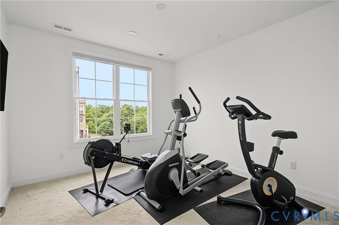Carpeted room with a double-hung window providing natural light and recessed ceiling lighting