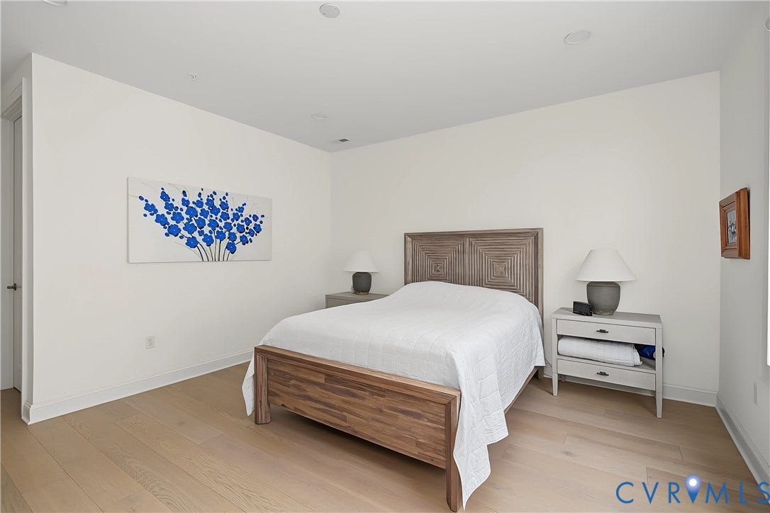 Light wood-finish flooring complements the neutral wall tones
