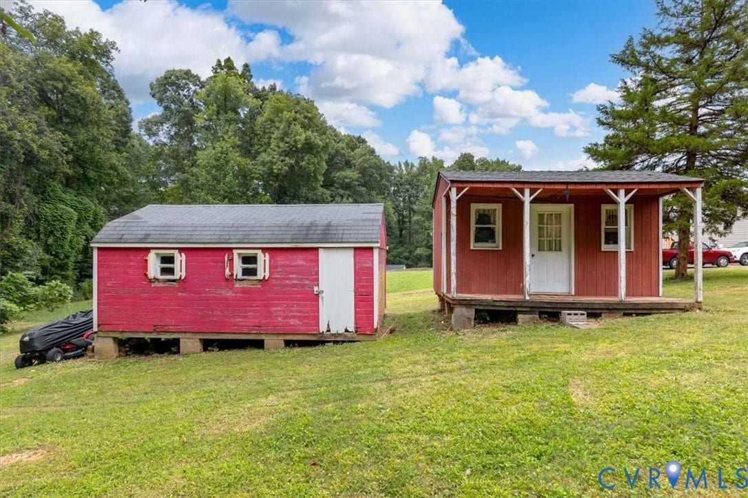 3308 Sylvania Road, Chesterfield, VA 23831 Two red outbuildings on a grassy expanse