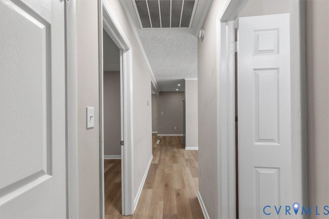 3308 Sylvania Road, Chesterfield, VA 23831 Hallway with wood-finish flooring, light-toned walls, crown molding, and white interior doors