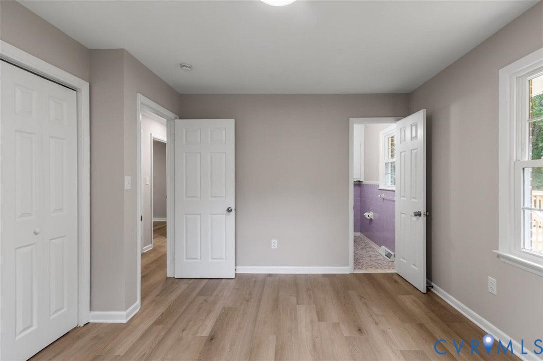 3308 Sylvania Road, Chesterfield, VA 23831 Wood-finish flooring, light grey wall paint, multiple paneled doors, and a double window with exterior visibility